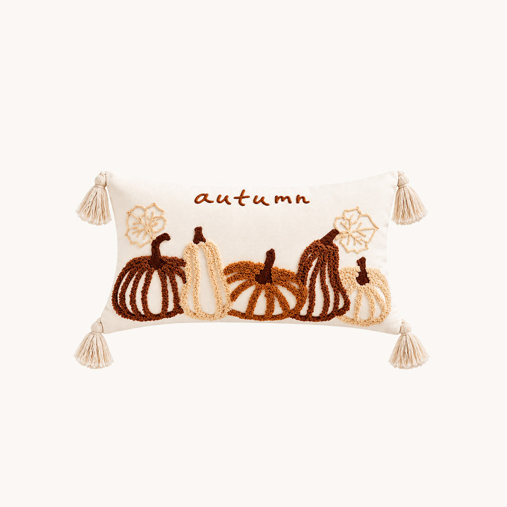 Front view of Harvestline cream 12x20 pumpkin lumbar pillow cover with raised embroidery and tassels