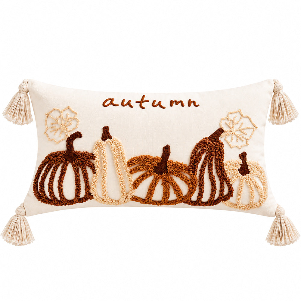 Autumn pumpkin tassel pillow cover displayed on a wooden console beneath a round mirror