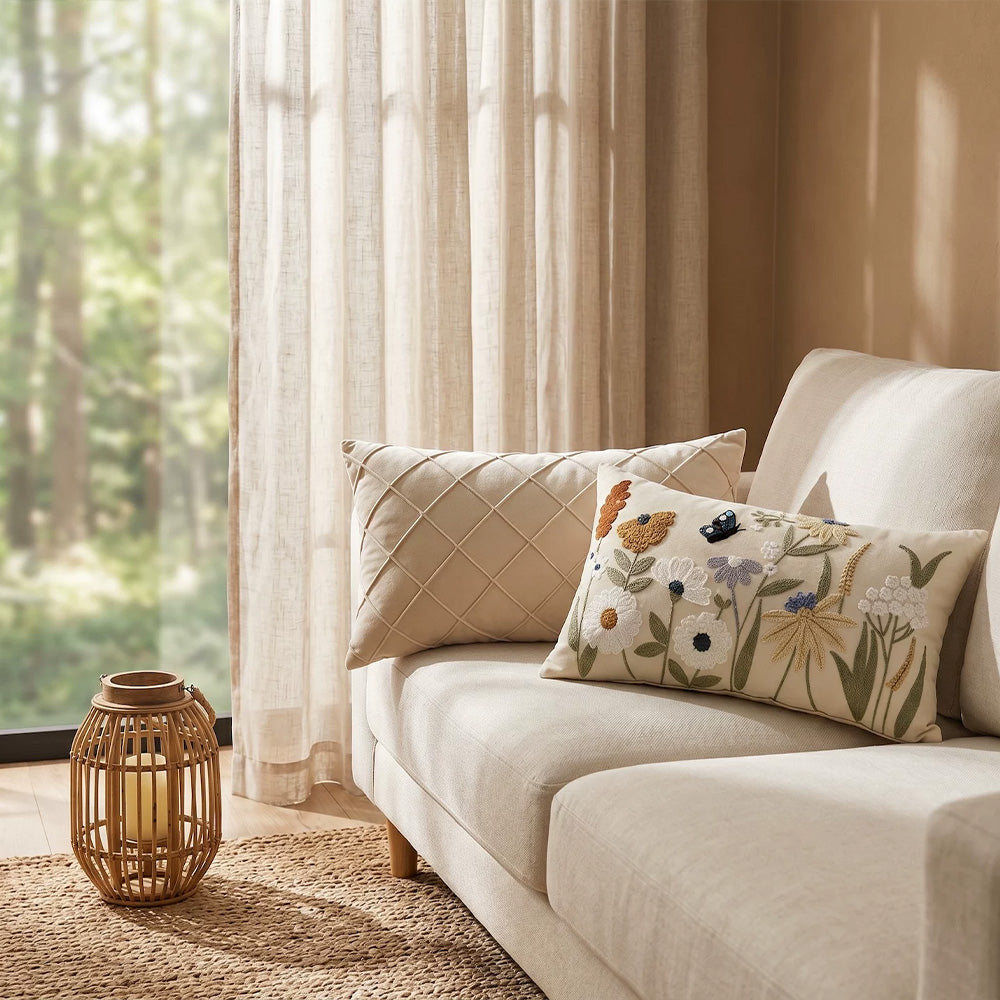 Butterfly embroidered wildflower lumbar pillow cover on a neutral armchair