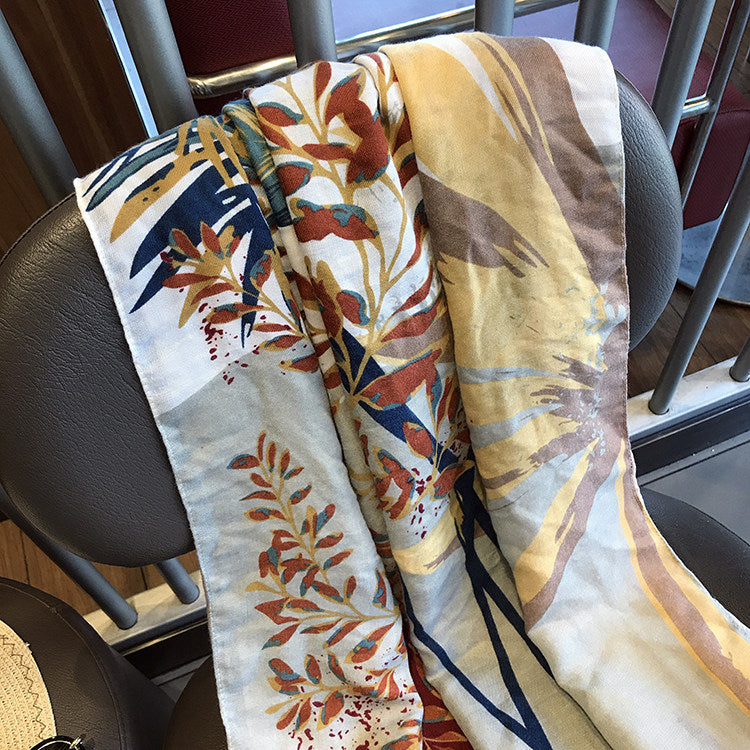 Tropic beach towel detail with tropical leaves and floral accents