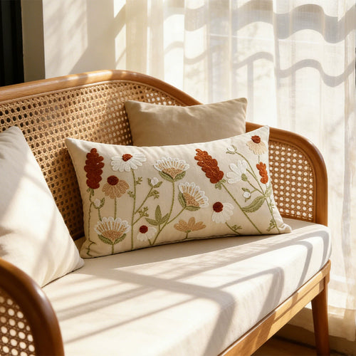 Ditsy burnt orange floral lumbar cover styled on a sofa