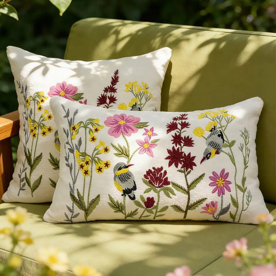 Songbird embroidered bird cushion cover styled on an indoor sofa