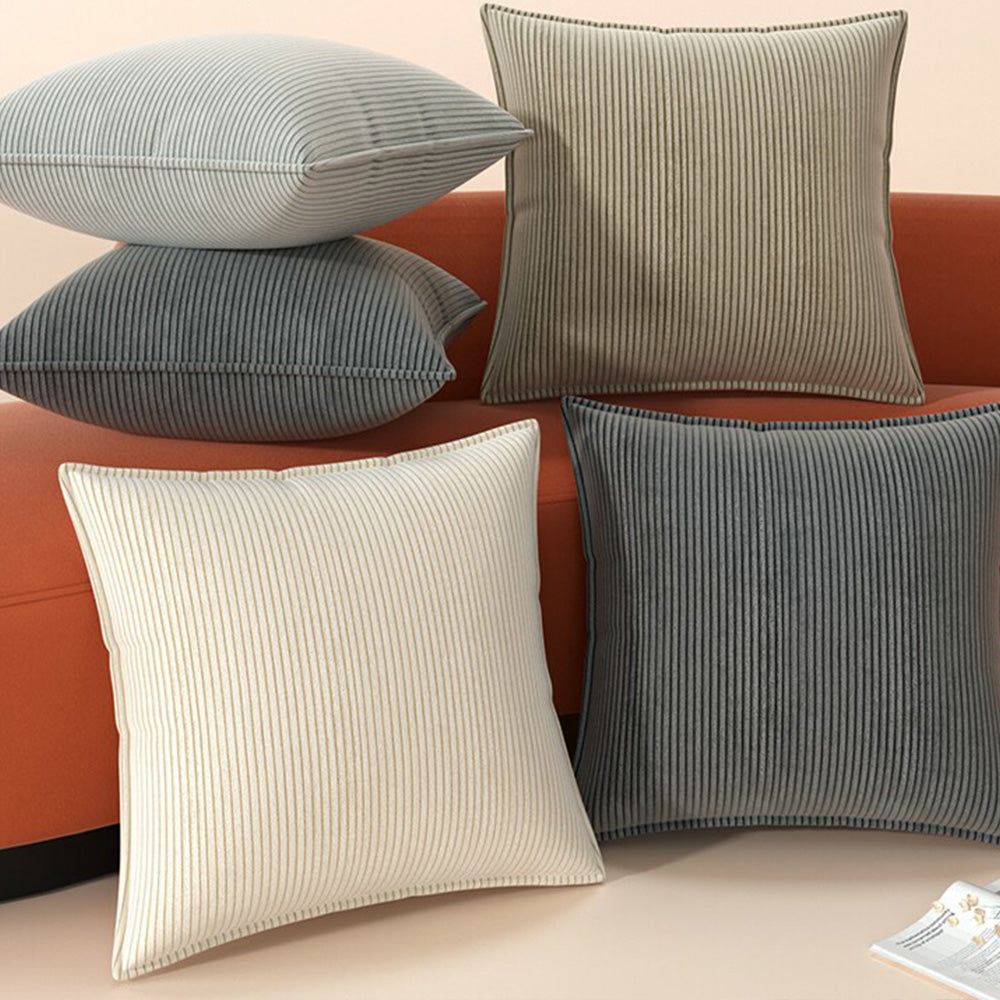 Four Ridge corduroy pillow cover colors arranged on a rust sofa