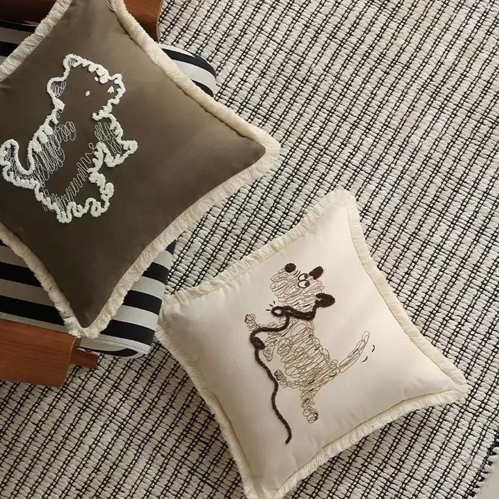 Outline embroidered dog cushion cover styled on a modern sofa