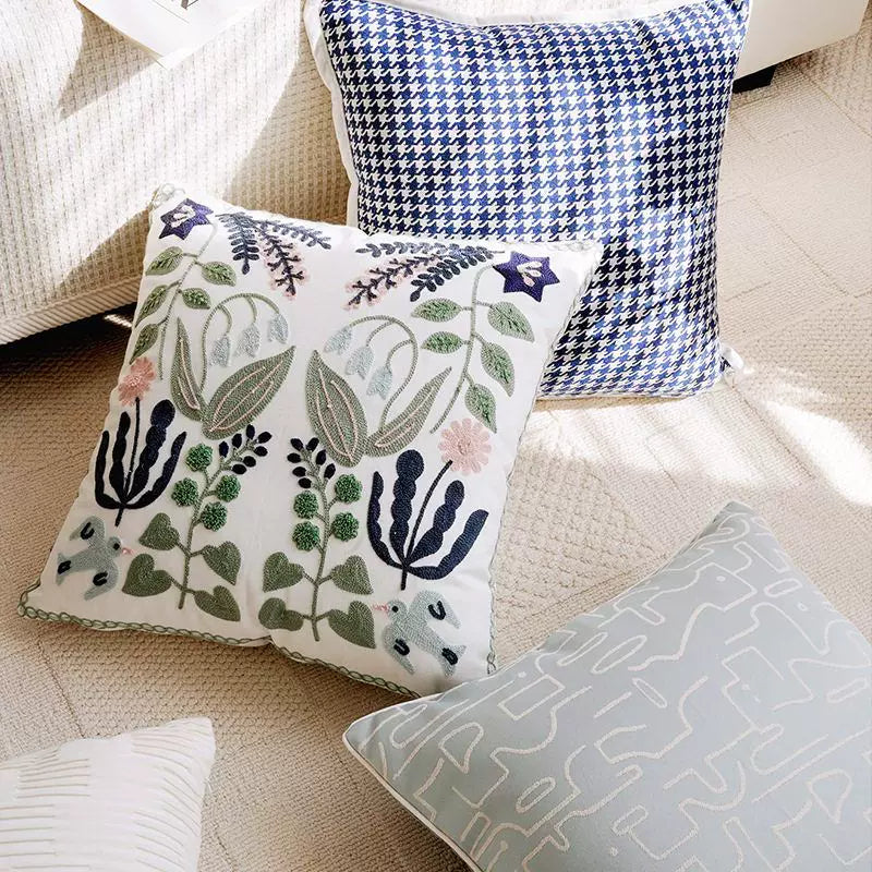 scandinavian embroidered floral pillow cover on modern living room sofa
