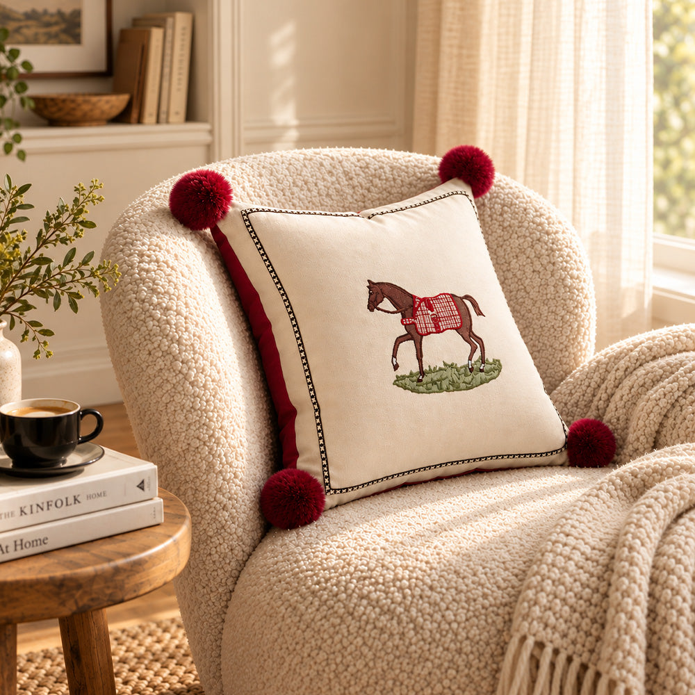 Redbrook equestrian pillow cover displayed on a cream chair in warm natural light