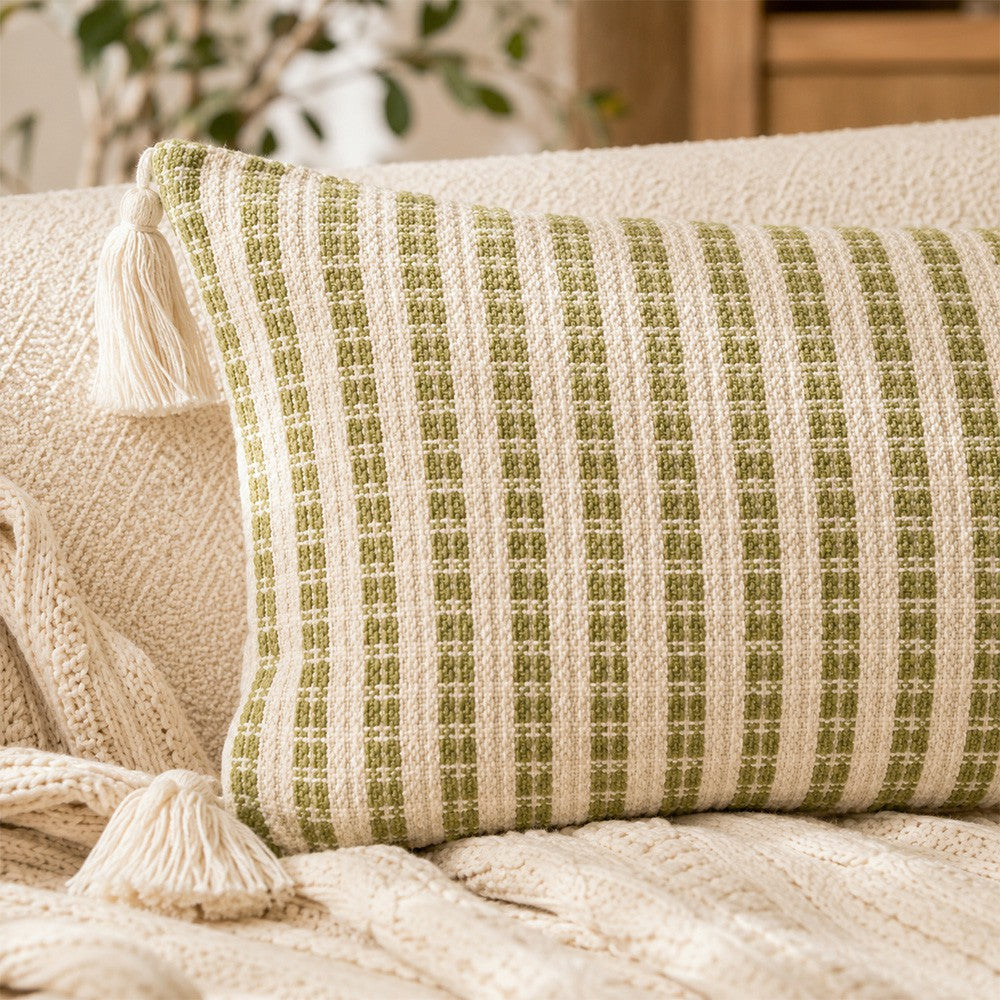 Close-up of Meadowline textured green stripe fabric and cream corner tassel