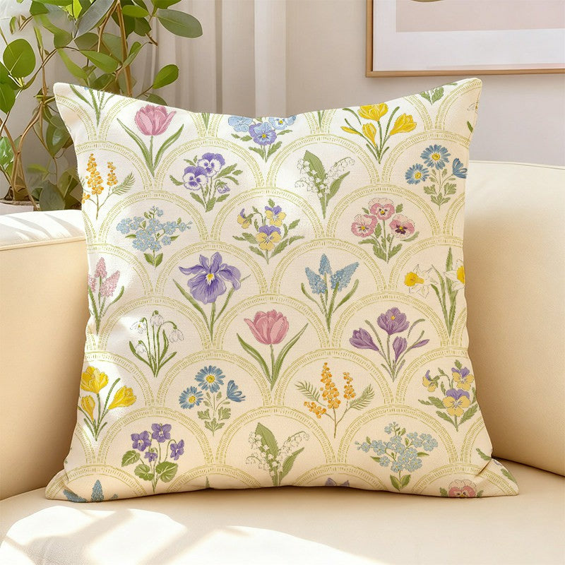 Two Herbarium wildflower pillow cover designs styled together on a modern sofa