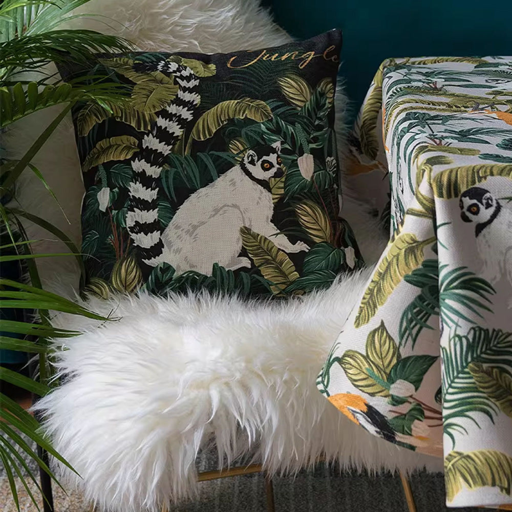 Lemur decorative pillow displayed with matching tropical table runner in a cozy jungle-inspired corner.