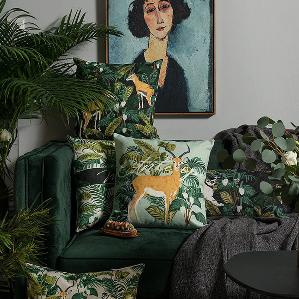 Rainforest botanical safari pillow covers arranged on a modern sofa