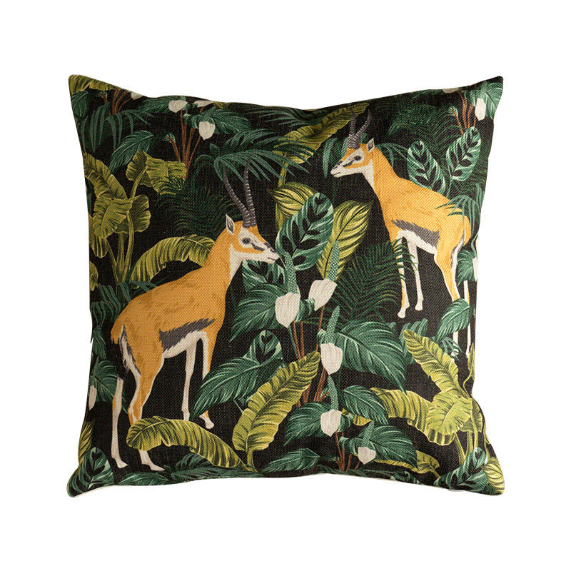 Safari antelope decorative pillow cover surrounded by tropical jungle plants