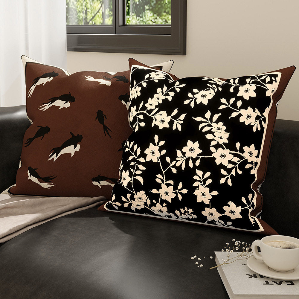 Inkstone floral and goldfish pillow cover designs displayed together on a sofa