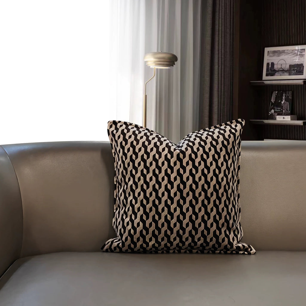 Cassian geometric pillow cover styled on a modern leather sofa