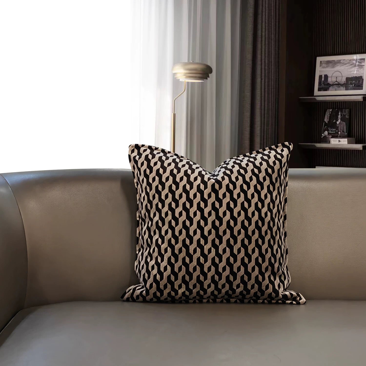 Cassian geometric pillow cover styled on a modern leather sofa