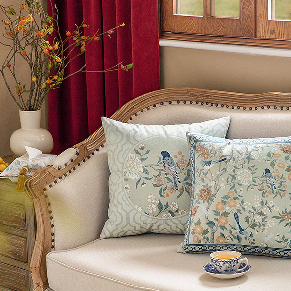 Bluebird bird and botanical covers styled on a classic couch