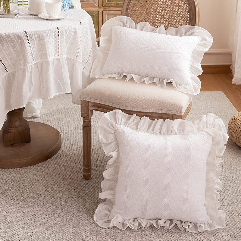 Two white Porcelain ruffle pillow cover styles displayed in a cottage room