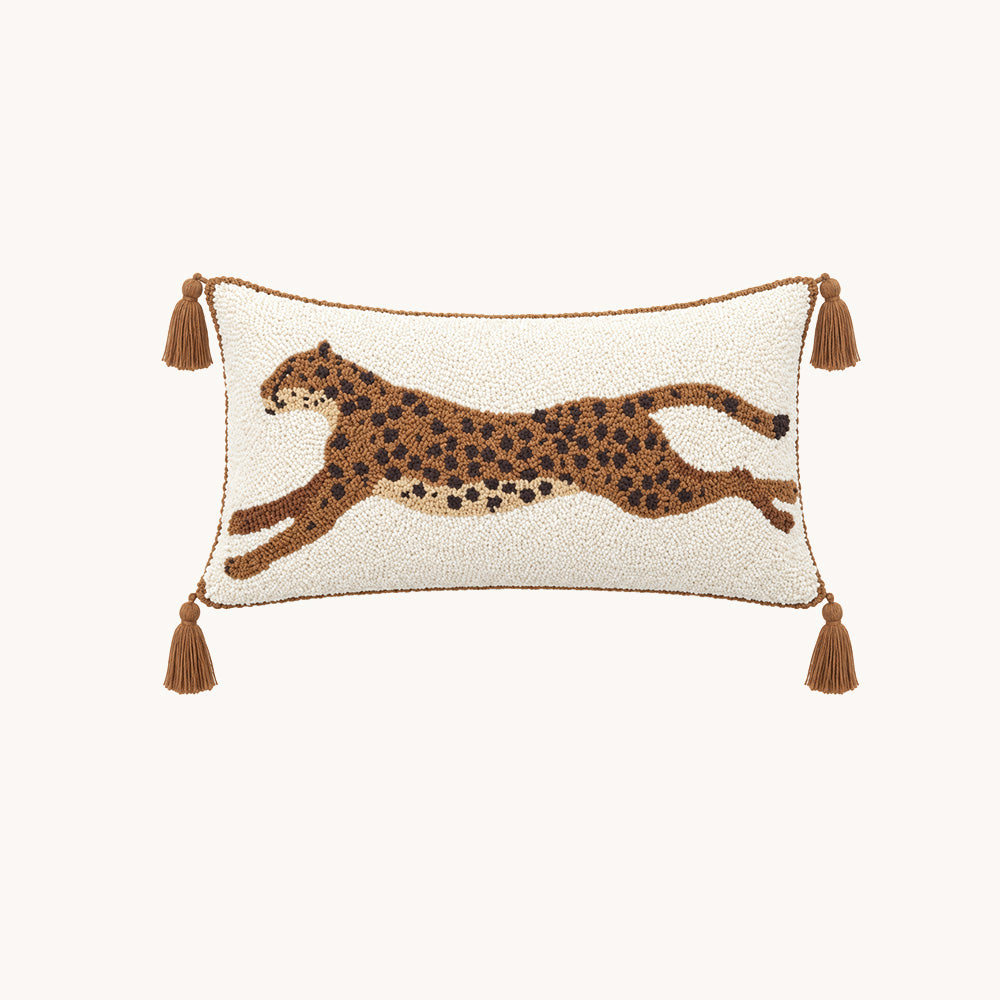 Front view of Prowl brown and cream tufted leopard 12x24 lumbar pillow cover with four tassels