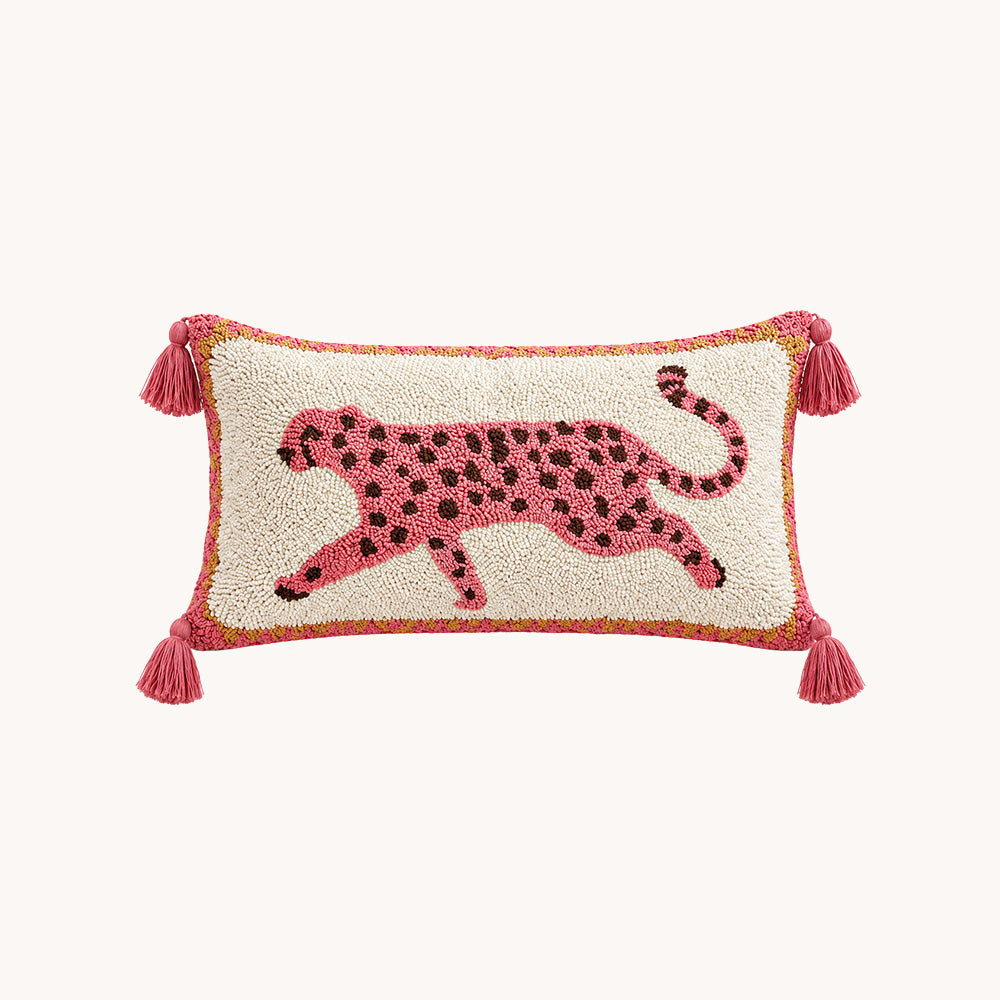 Prowl pink leopard tassel lumbar pillow cover styled on a cream sofa with blush accents