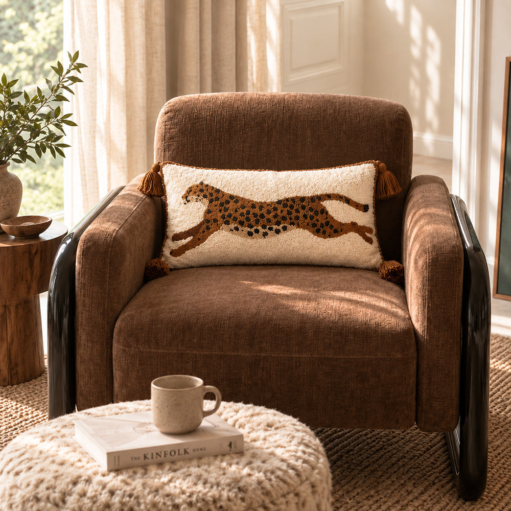 Brown tufted leopard lumbar pillow cover displayed on a warm brown accent chair