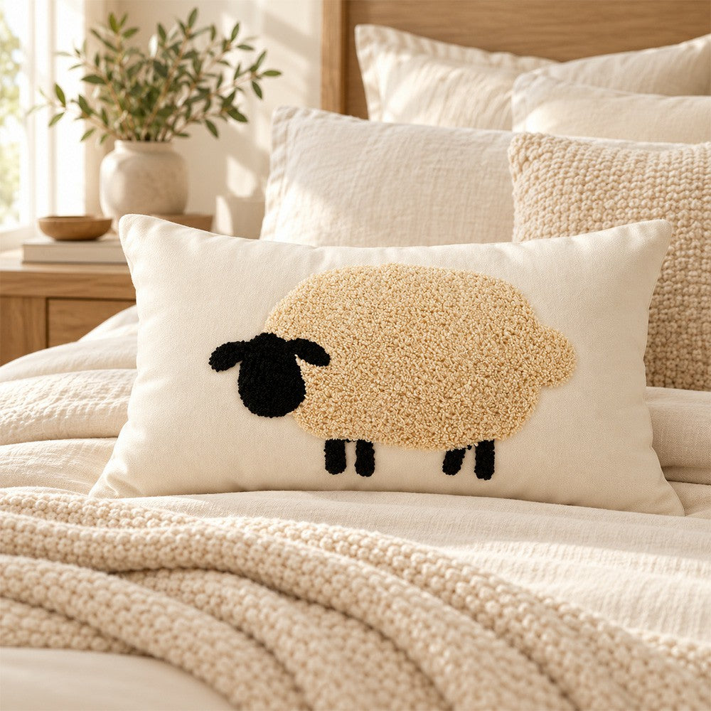 Sheep lumbar pillow displayed on a neatly layered neutral bed.