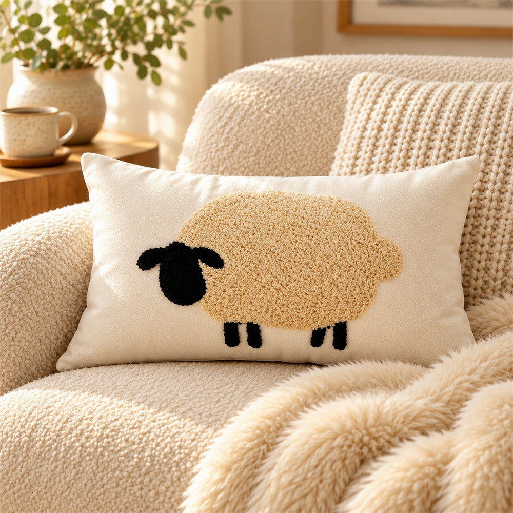 Pasture farmhouse sheep lumbar pillow cover beside a mug and open book