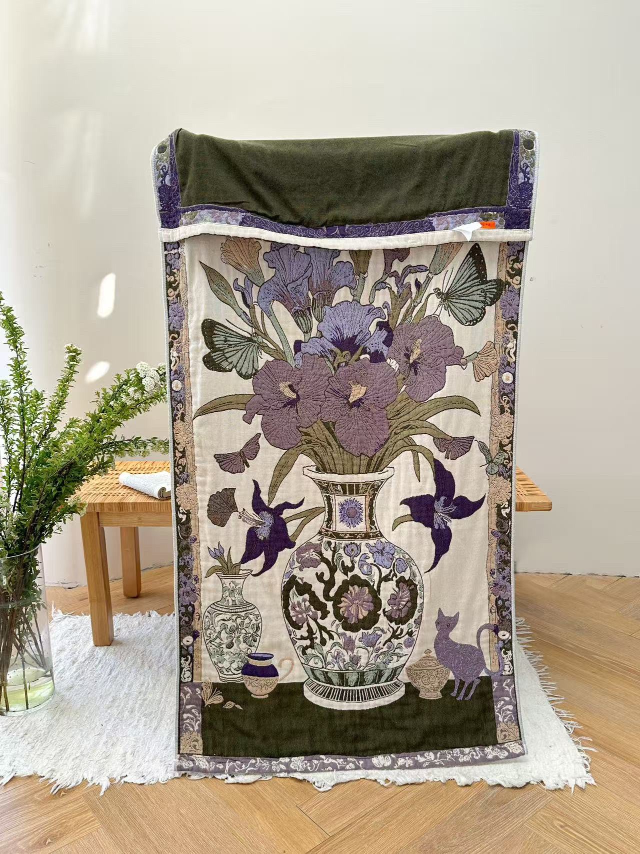 Floribunda purple botanical cotton throw blanket draped over a chair