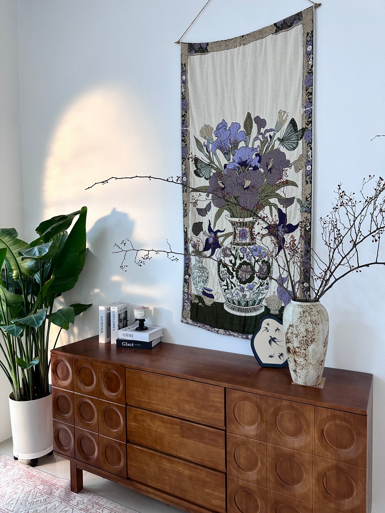 Floribunda purple floral woven throw displayed on a living room wall