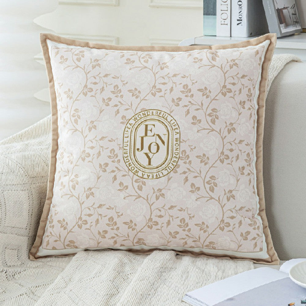 Keepsake beige botanical monogram pillow cover styled on a light sofa