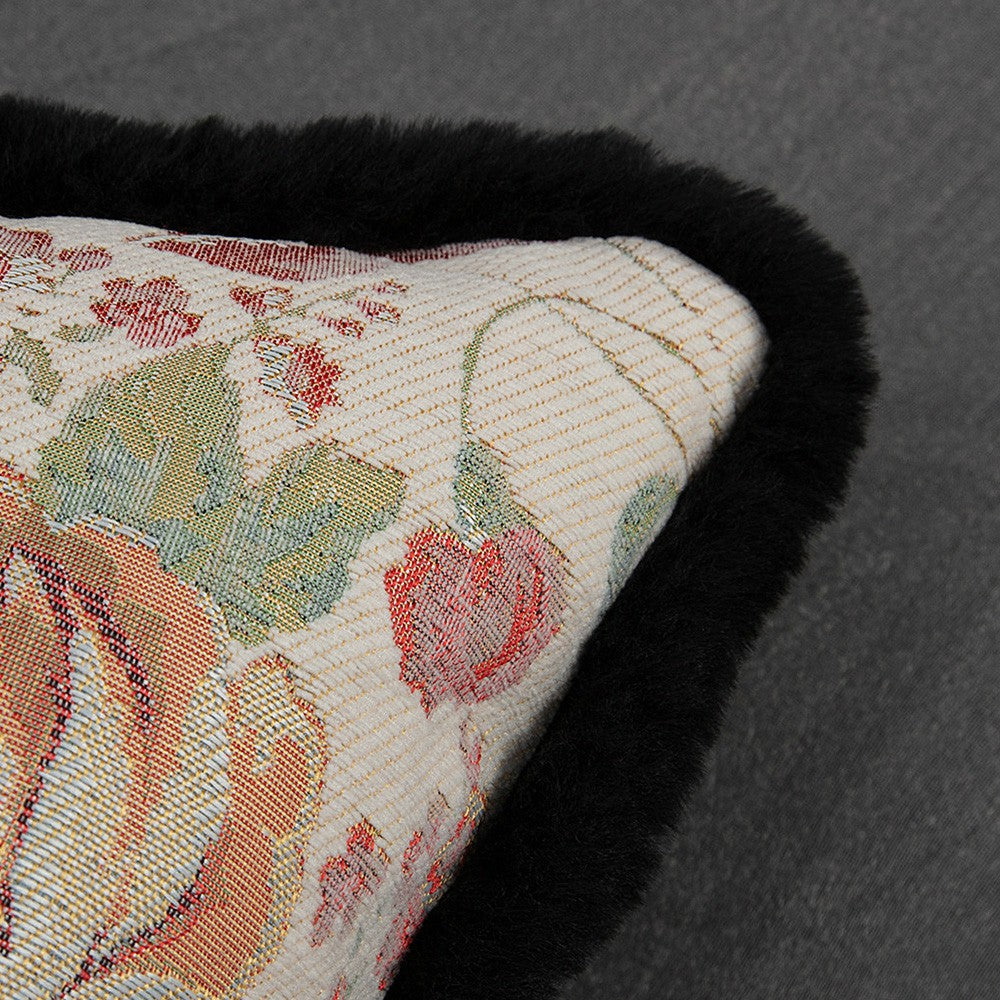 Close-up of red rose tapestry weave and black plush trim on Chateau pillow cover
