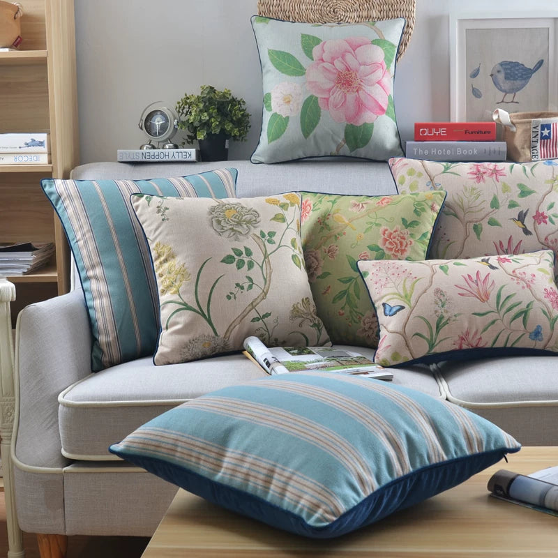 Gardenflight floral and striped pillow cover designs on a sofa