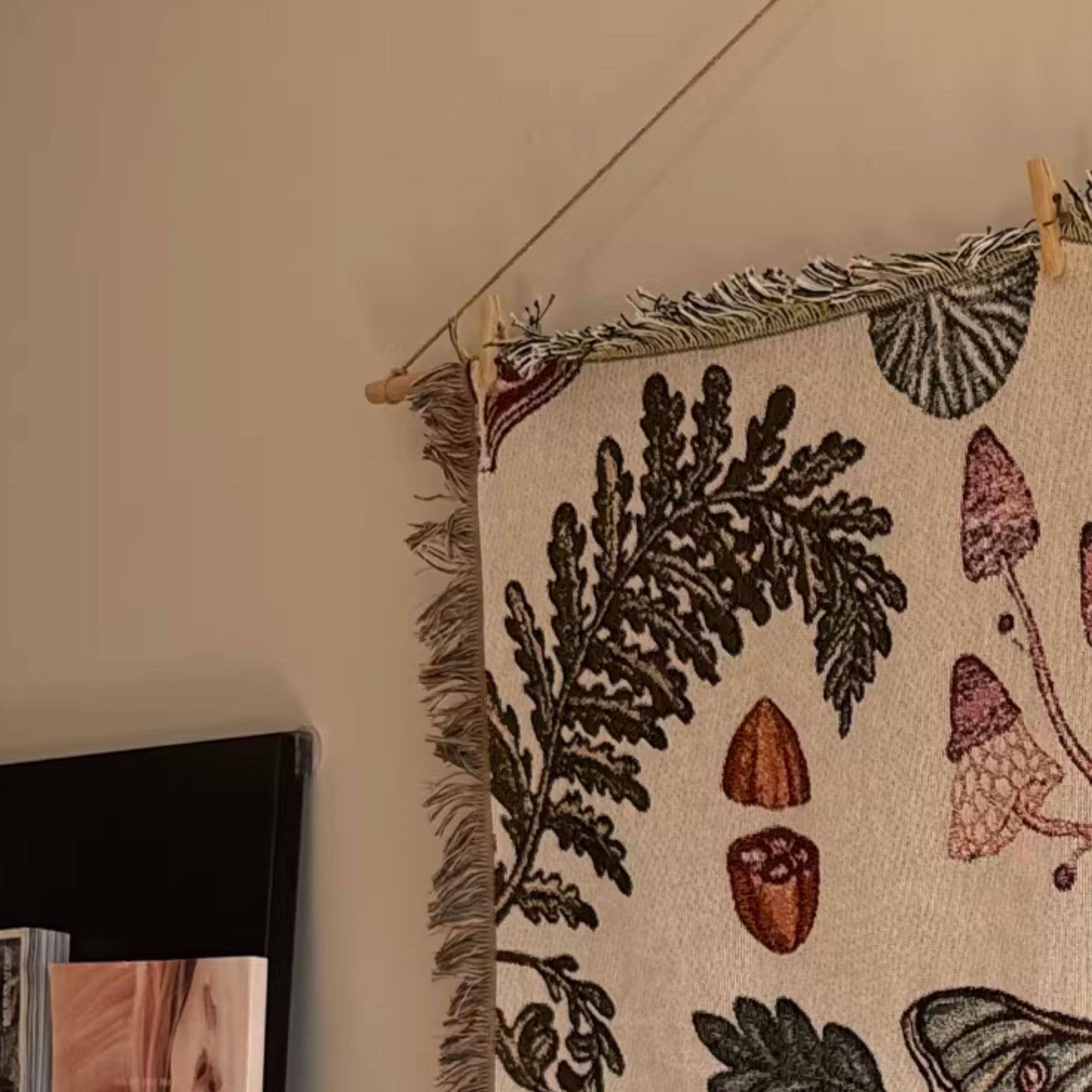Close-up of Mushroom Grove tapestry top fringe woven edge and hanging rod