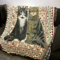Whisker cat throw blanket draped over a black sofa